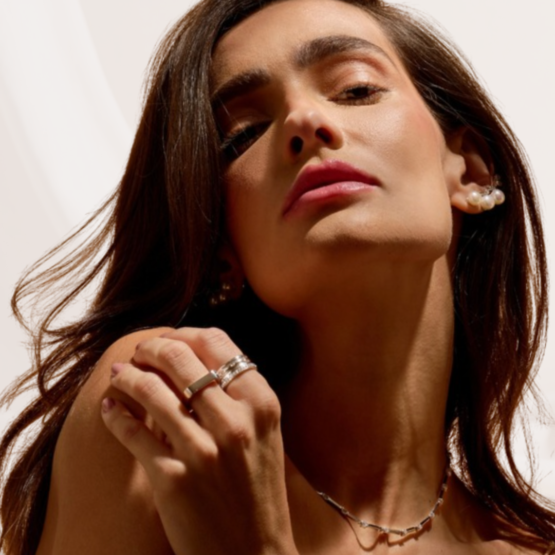 Close-up of a woman with jewelry on a neutral background