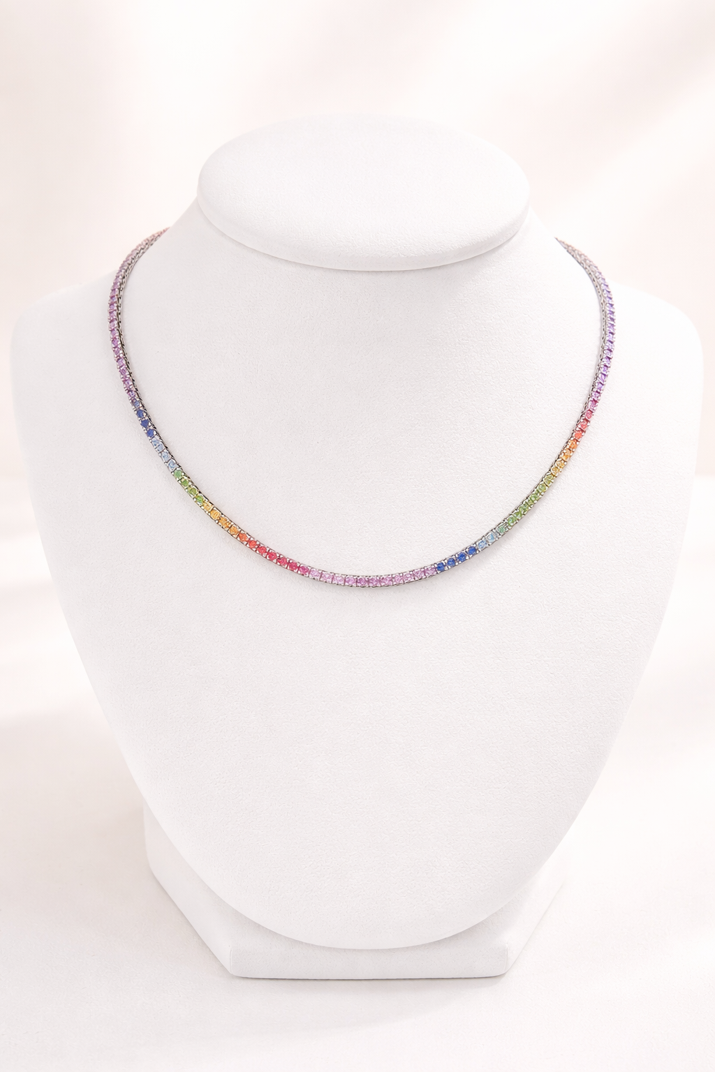 Multicolored beaded necklace on a white mannequin bust.