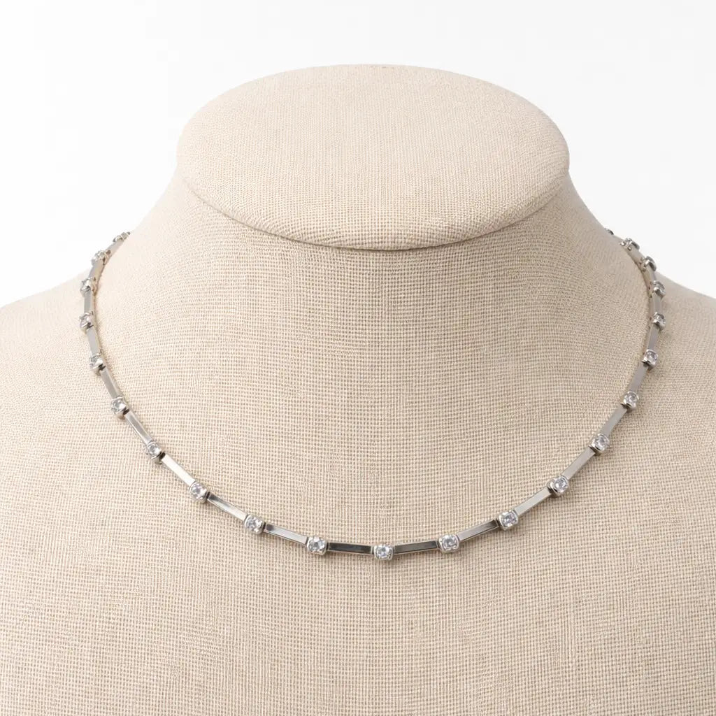 Necklace on a mannequin bust with a white background