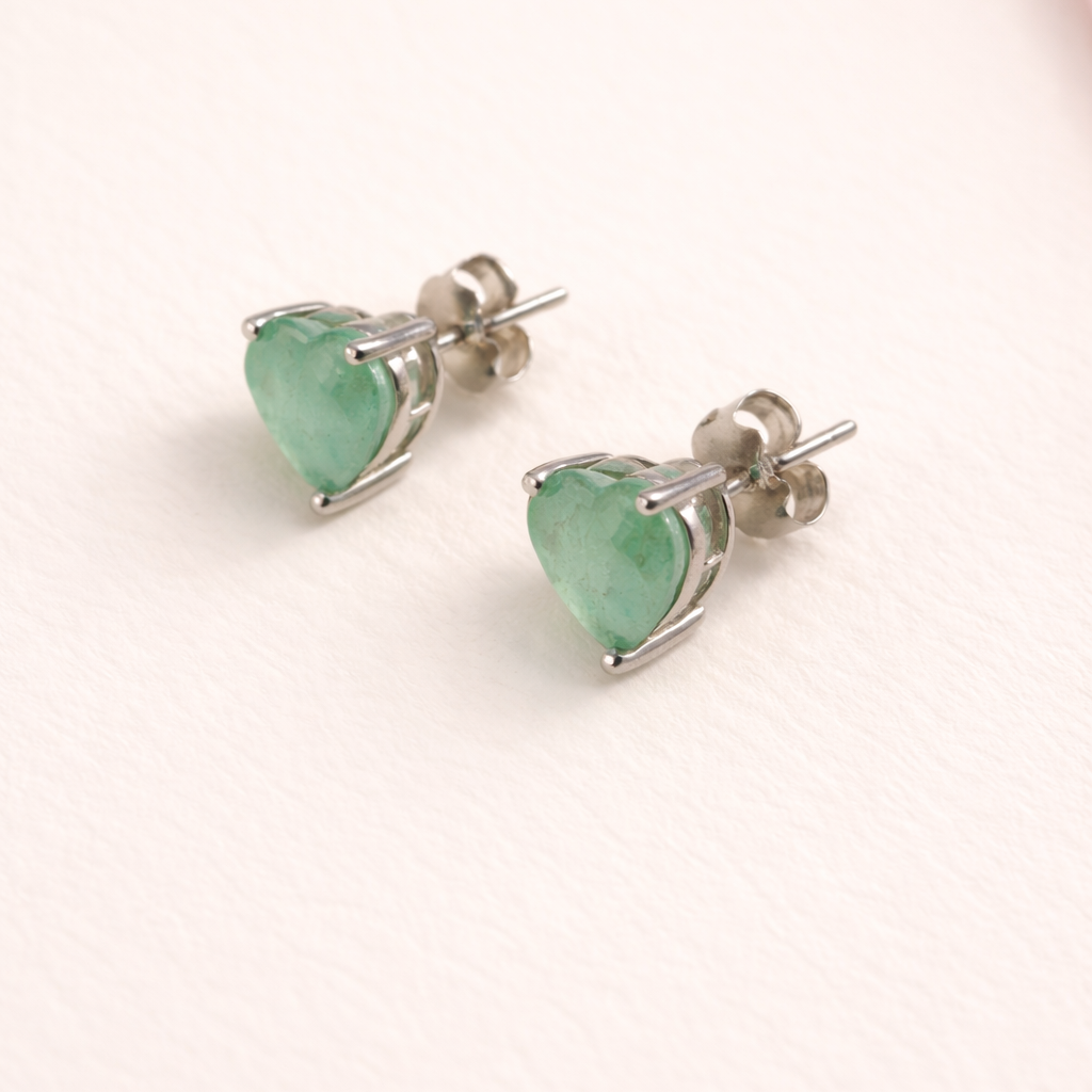 Heart-shaped mint green earrings on a white background