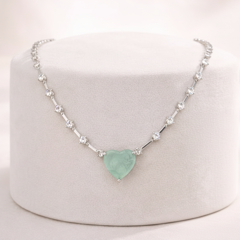 Mint green heart-shaped jewelry necklace on a white background