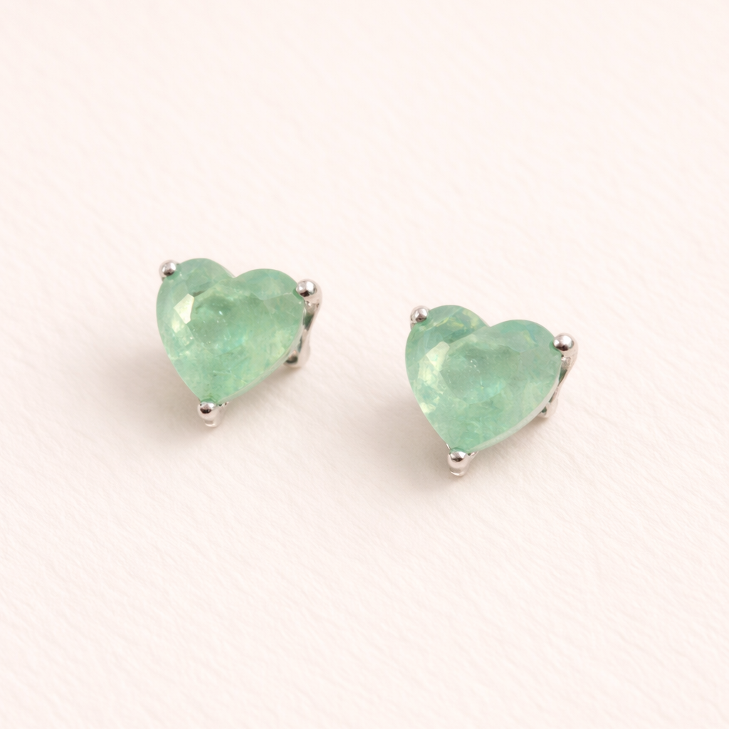 Heart-shaped mint green earrings on a white background