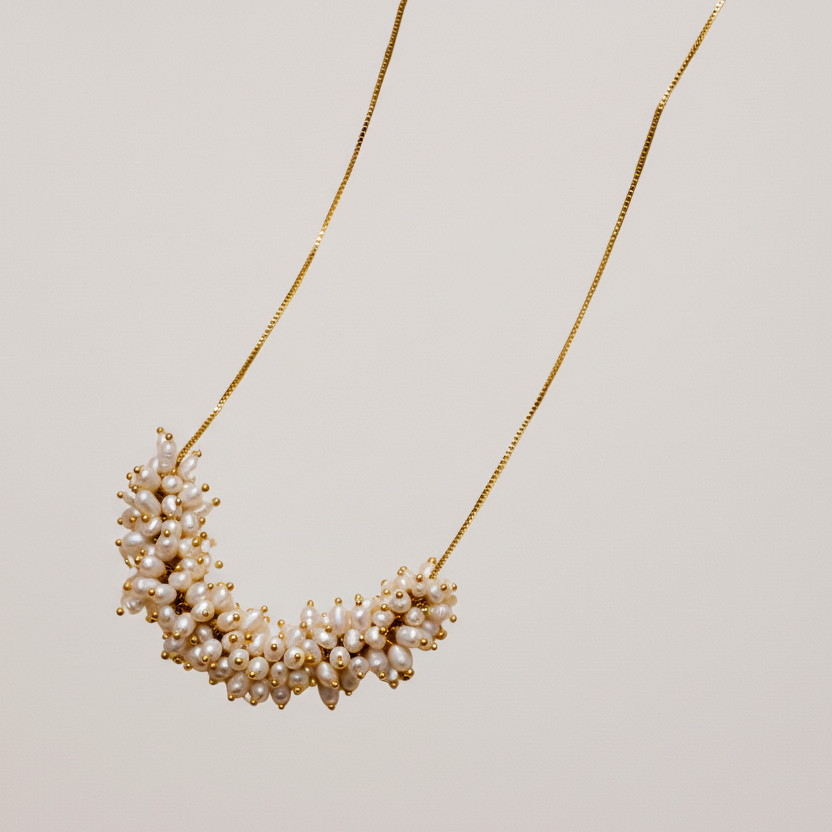 Pearl necklace on a light beige background