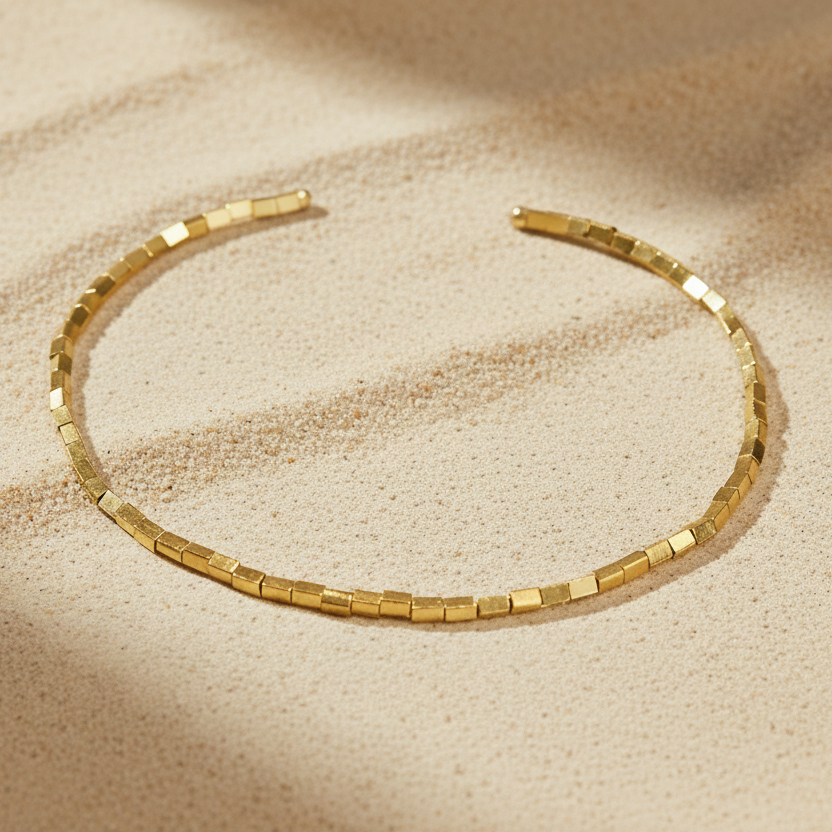 Gold choker in a sand background