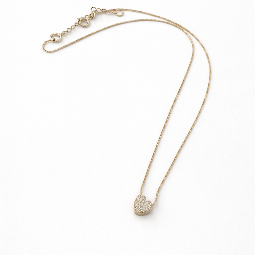 Gold necklace with a heart-shaped pendant on a white background