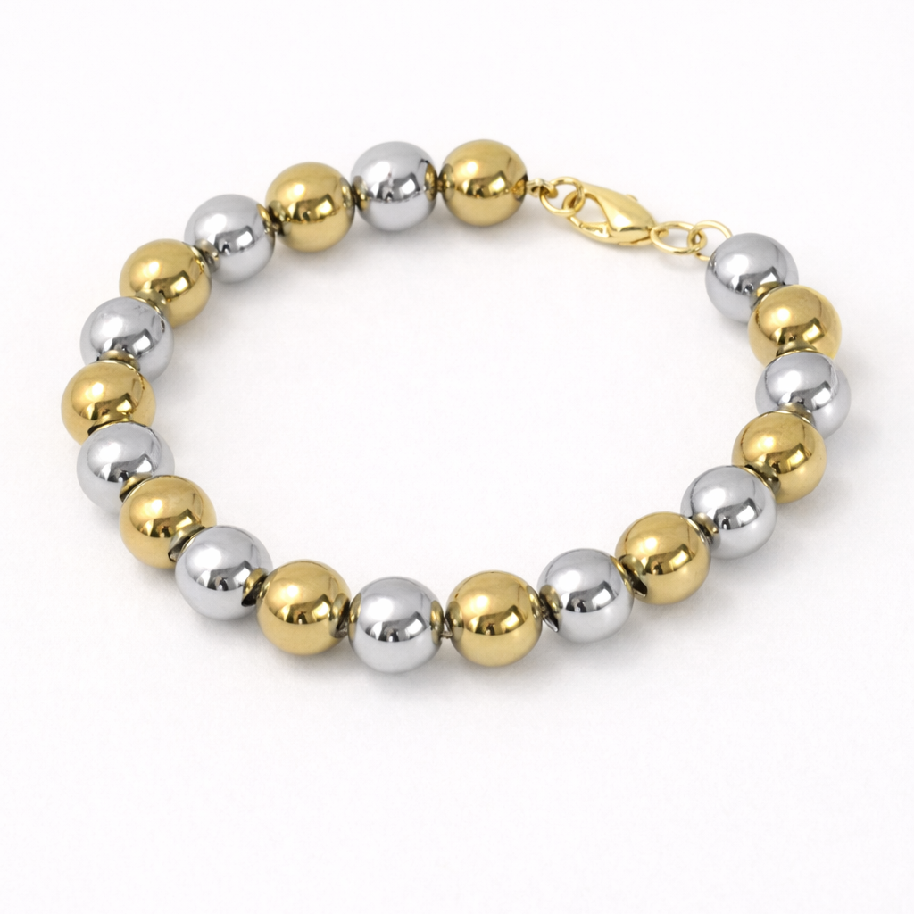 Bracelet with gold and silver beads on a white background