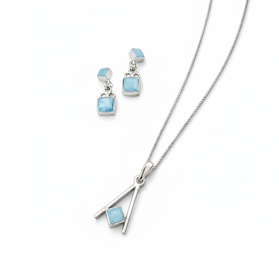 Silver necklace and earrings with blue stones on a white background