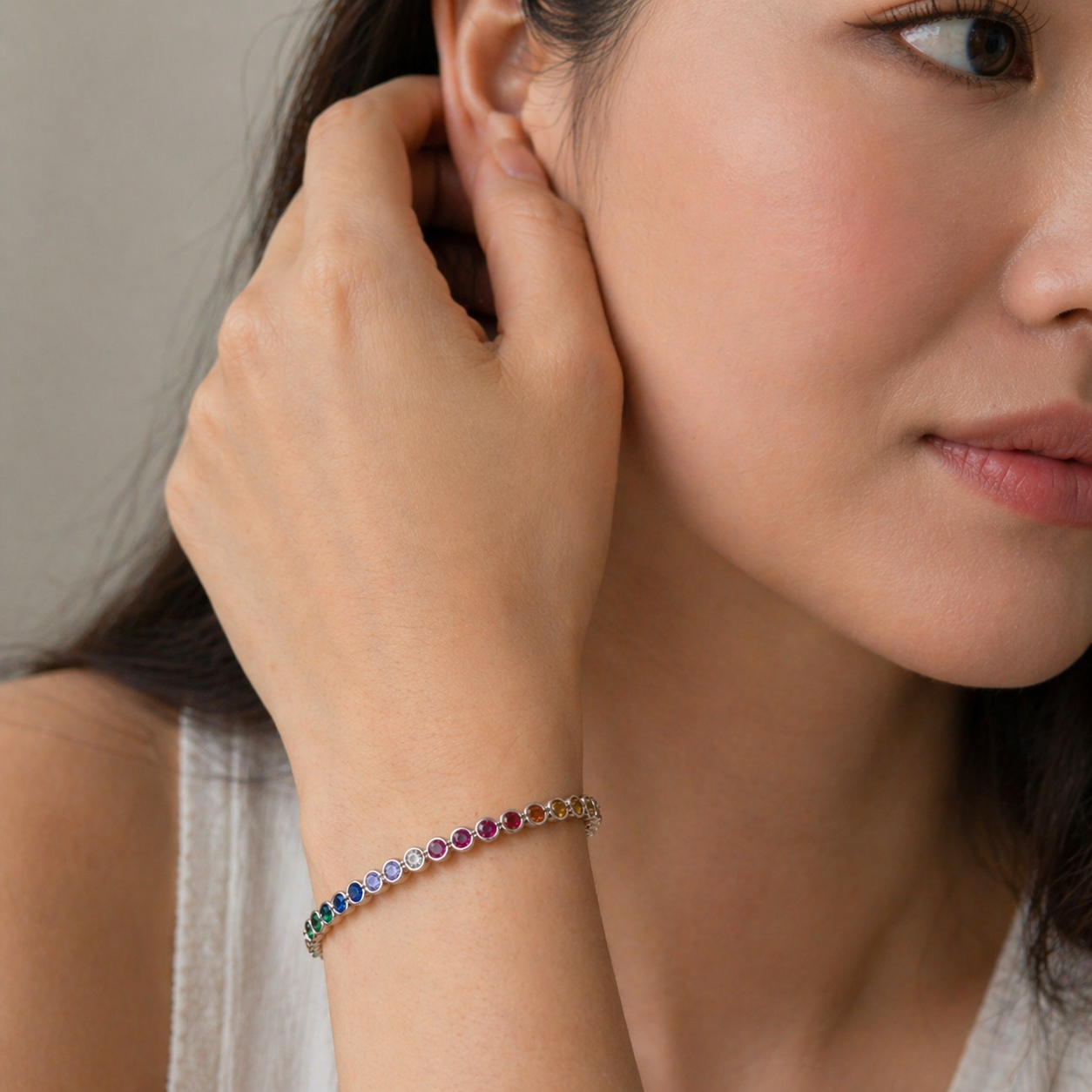 Close-up of a woman wearing a colorful bracelet on her wrist.
