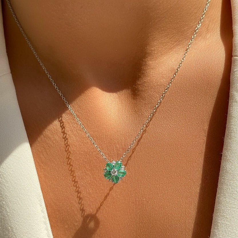 Necklace with a green gemstone pendant on a person's neck