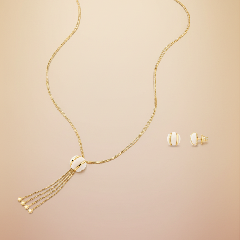 Gold necklace with tassel and matching earrings on a white background