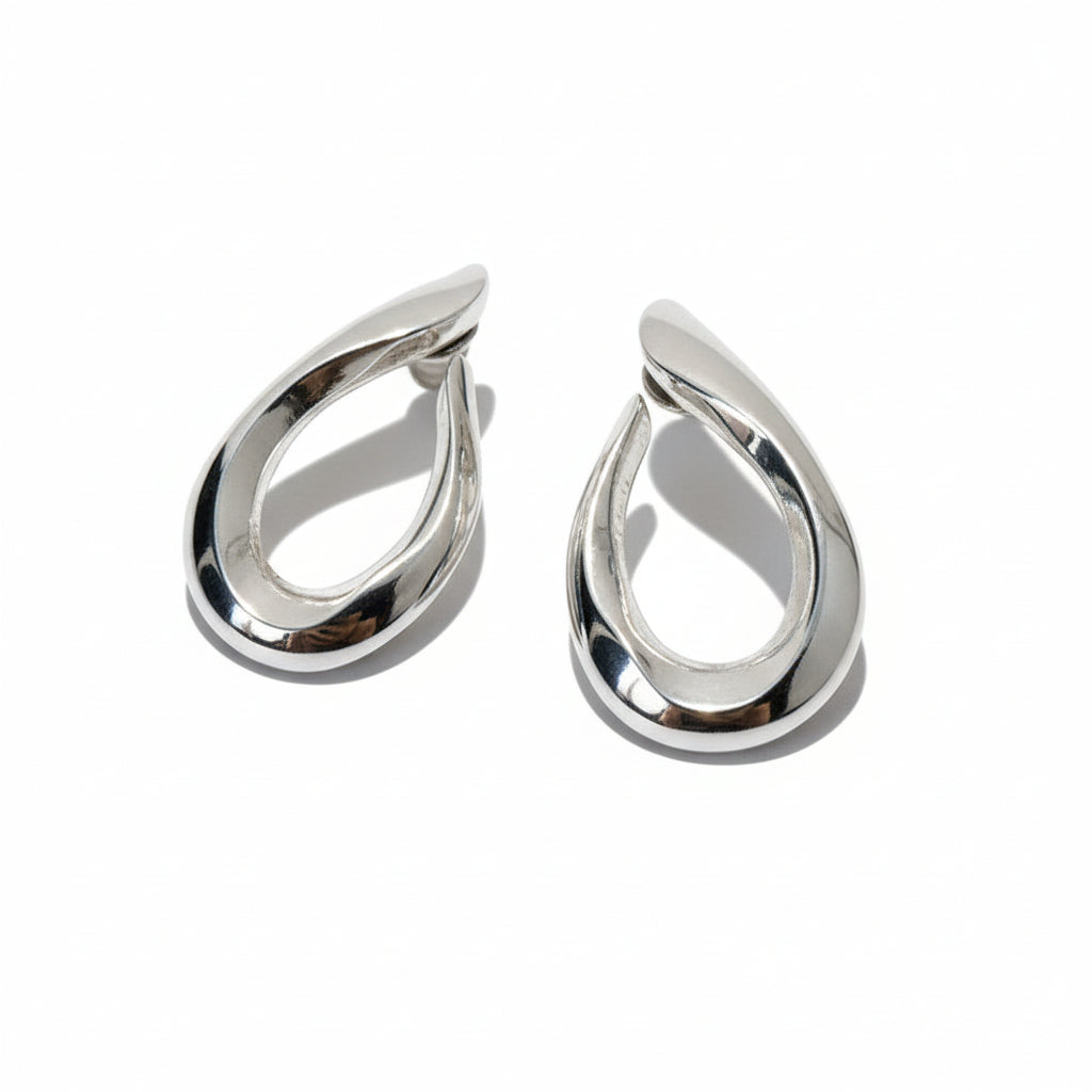 Pair of silver earrings on a light gray background