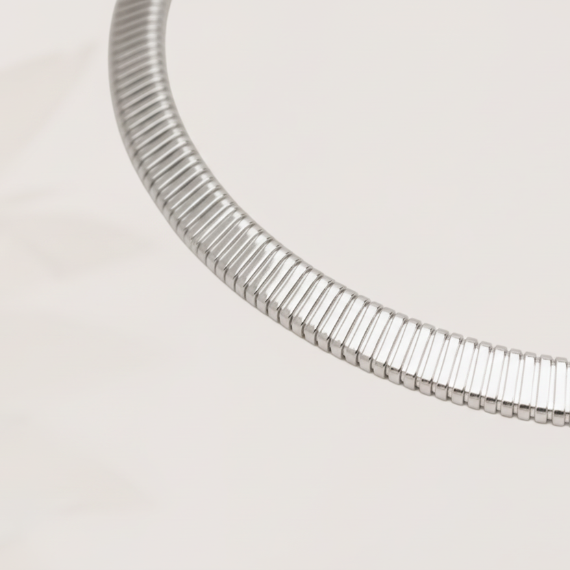 Silver necklace on a light beige background