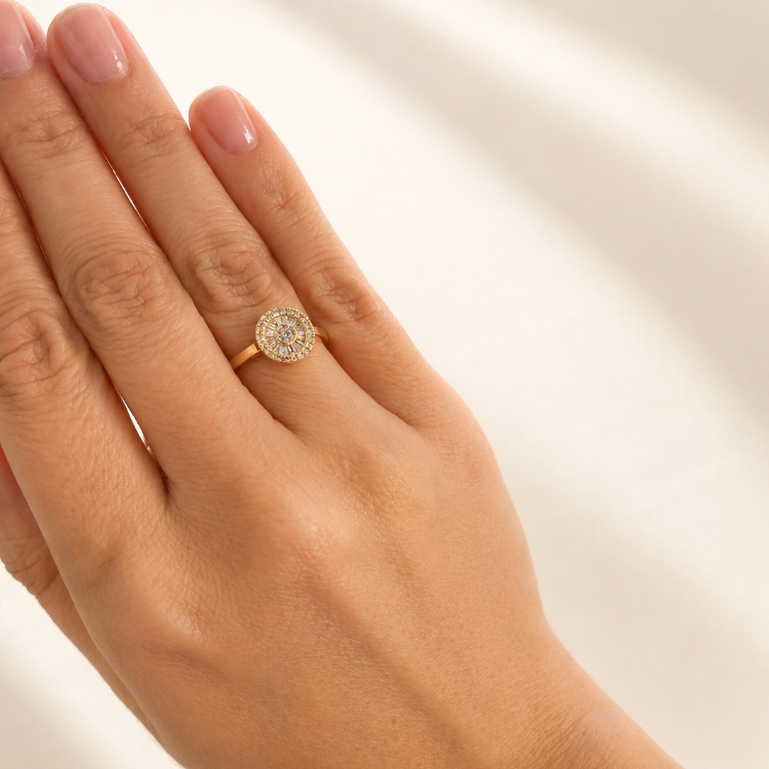Hand wearing a gold ring with a zirconias on a light background