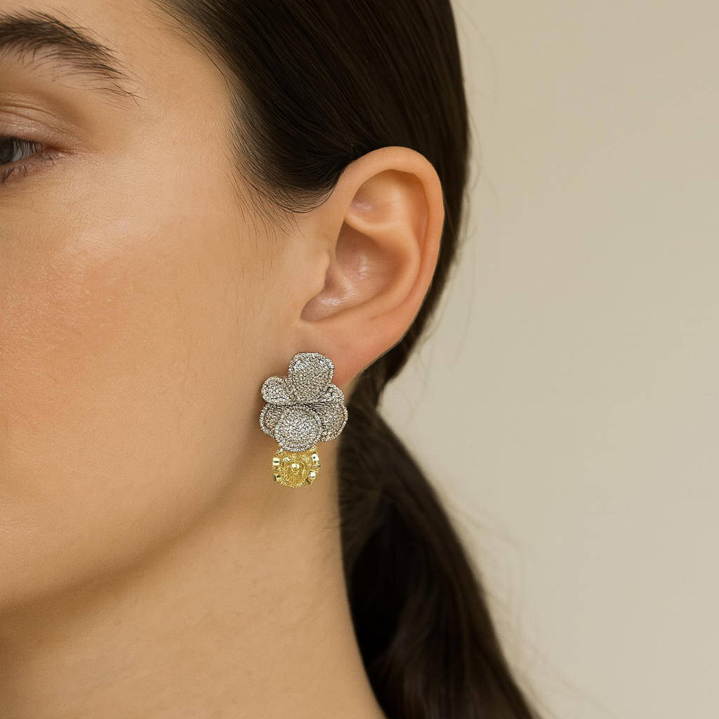 Close-up of a woman wearing a floral earring with a beige background