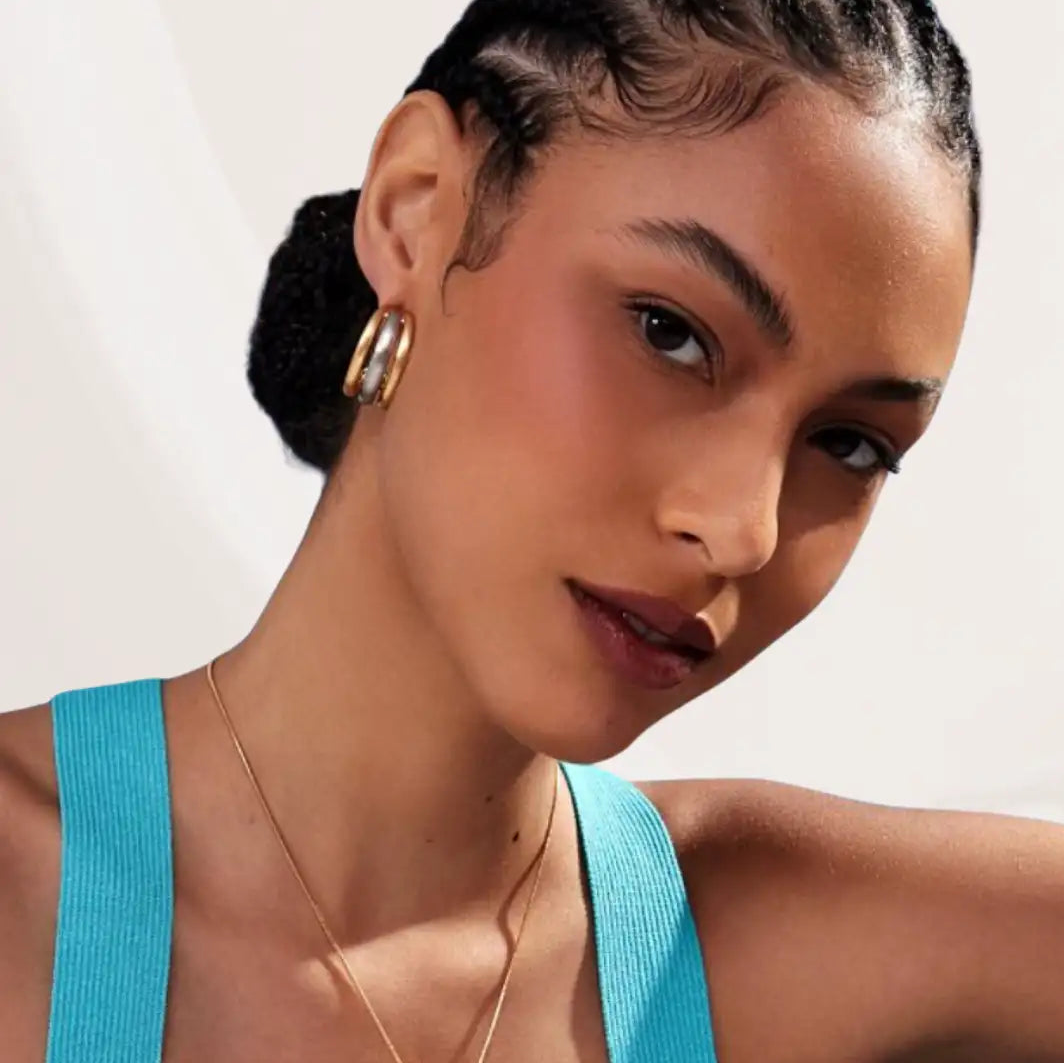 Woman wearing a blue top with a neutral background